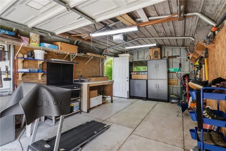 Garage with a workshop area and a garage door opener