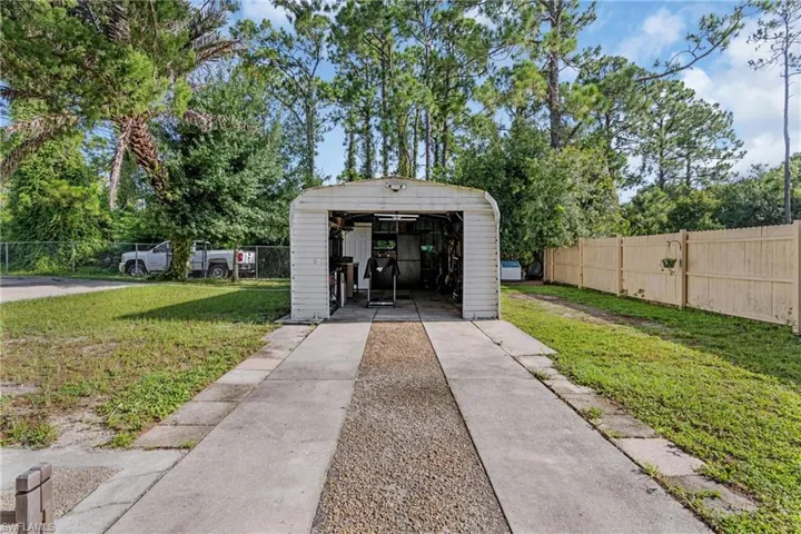 View of community with a lawn and an outdoor structure