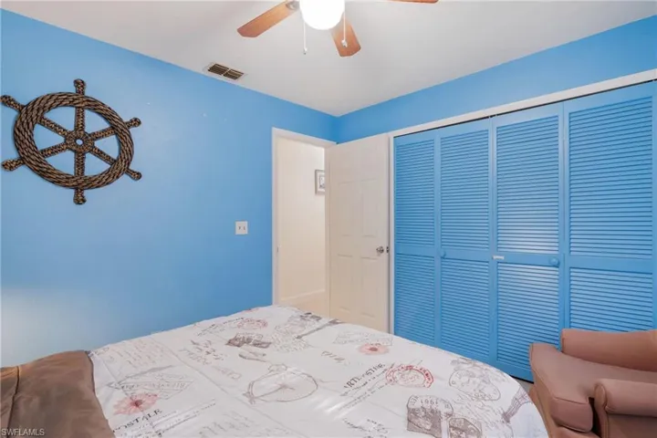 Bedroom with ceiling fan and a closet