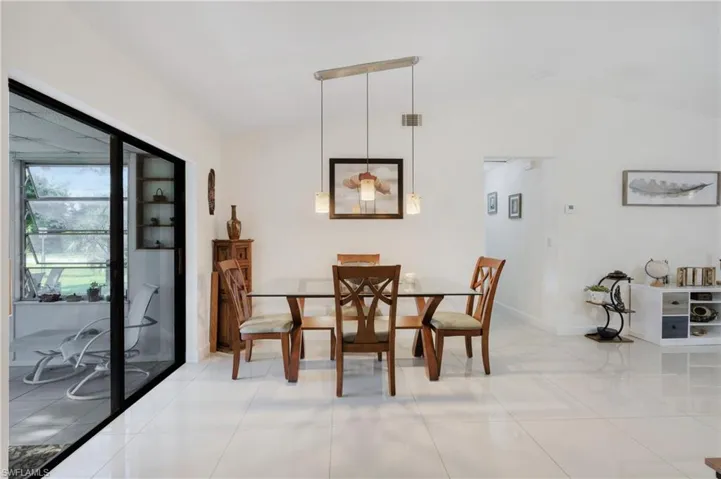 Dining space featuring vaulted ceiling and light tile patterned floors