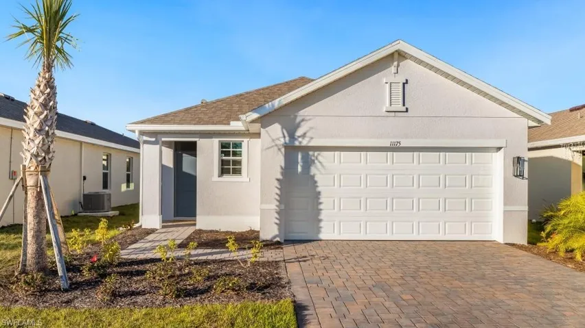 Ranch-style house with central AC unit, a shingled roof, stucco siding, a garage, and decorative driveway