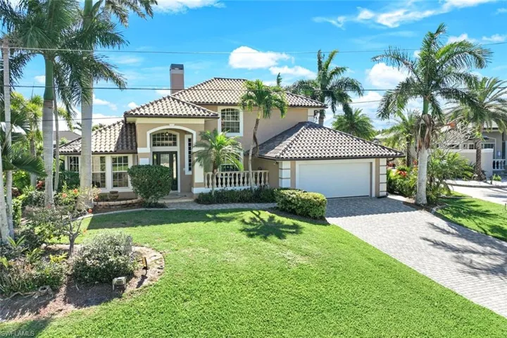 Front of home with block paved driveway