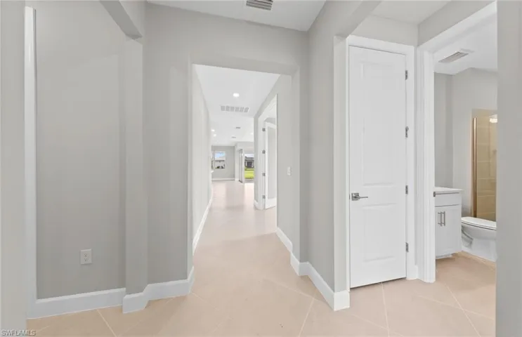 Hallway with light tile patterned flooring