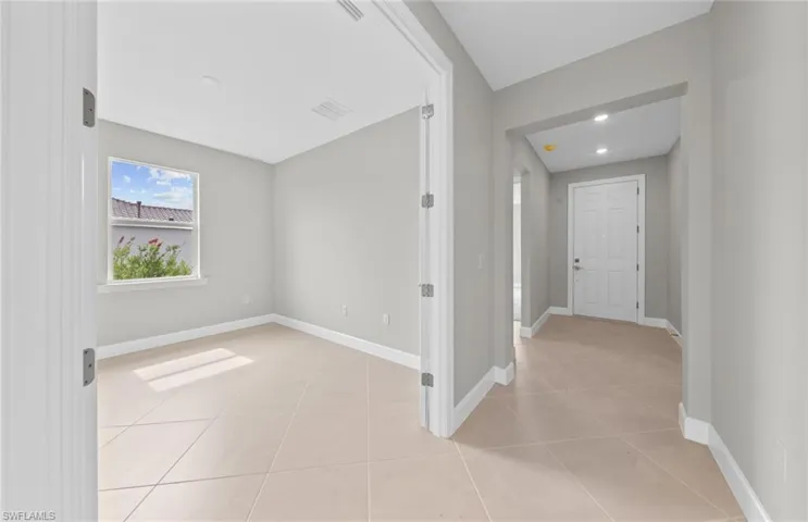Corridor featuring light tile patterned floors