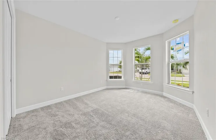 Carpeted empty room with a wealth of natural light