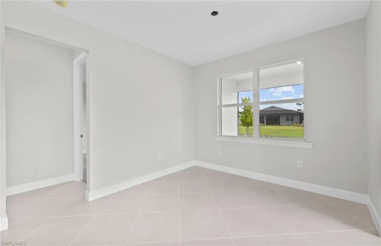 Unfurnished room featuring light tile patterned floors