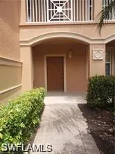 Doorway to property featuring stucco siding