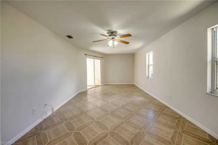 Spare room with a ceiling fan and baseboards