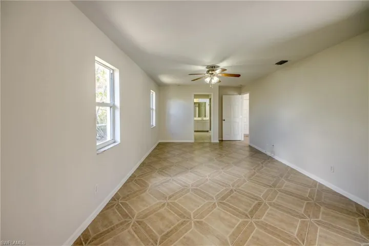 Spare room featuring ceiling fan and baseboards