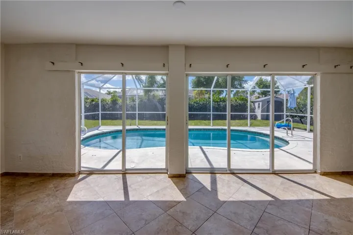 Outdoor pool featuring a sunroom