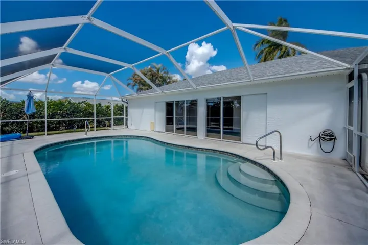Swimming pool featuring a lanai, a sunroom, and a patio