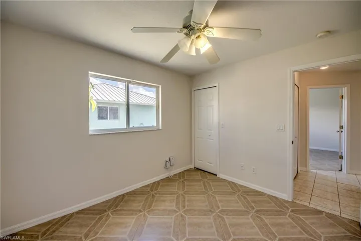 Unfurnished bedroom with a closet and ceiling fan