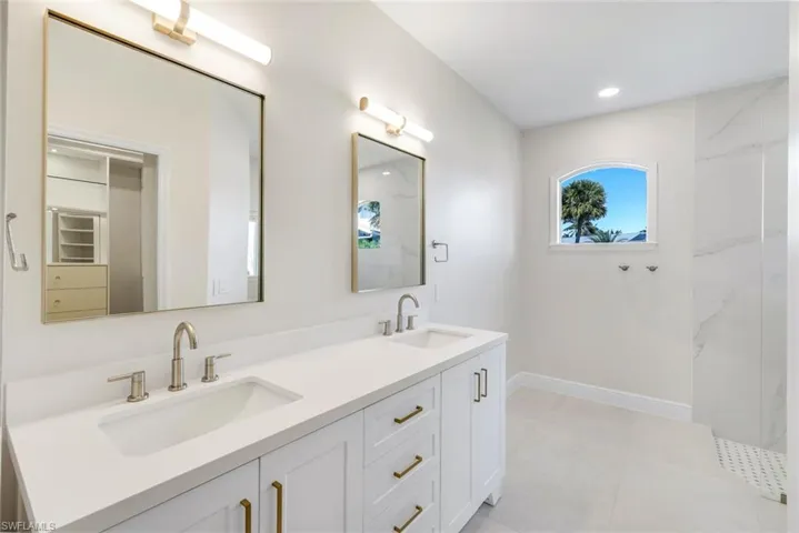 Primary  bath featuring double vanity and recessed lighting