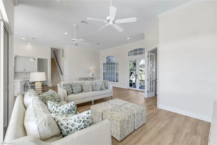 Living room featuring light wood-style floors, french doors, ornamental molding, recessed lighting, and ceiling fan