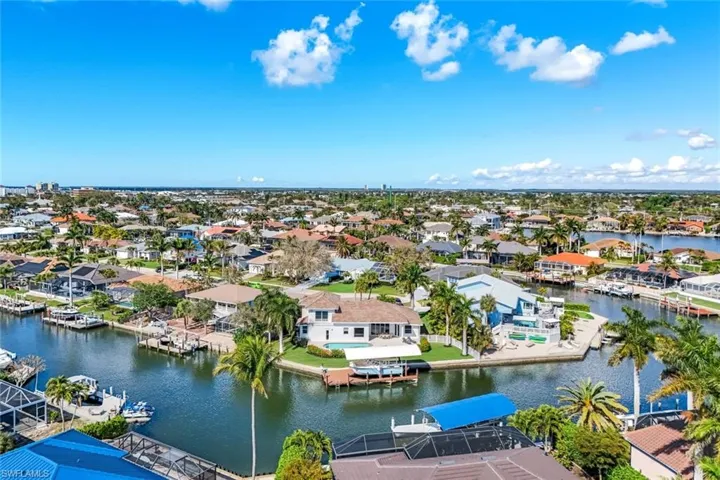 Aerial view of residential area featuring a nearby body of water