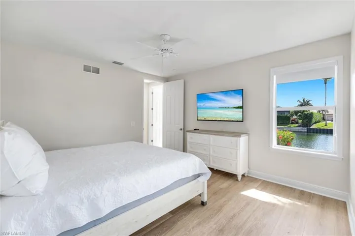 Bedroom with light wood-type flooring and a ceiling fan
