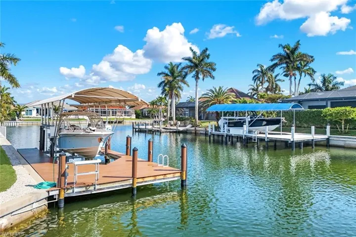 Dock area with boat lift and a water view