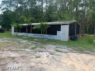 View of outbuilding featuring an outdoor structure and driveway
