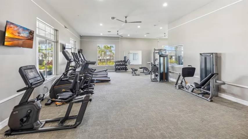 Gym featuring a ceiling fan, recessed lighting, baseboards, and carpet