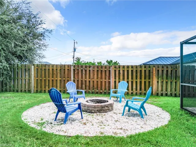 View of yard with a patio area and an outdoor fire pit