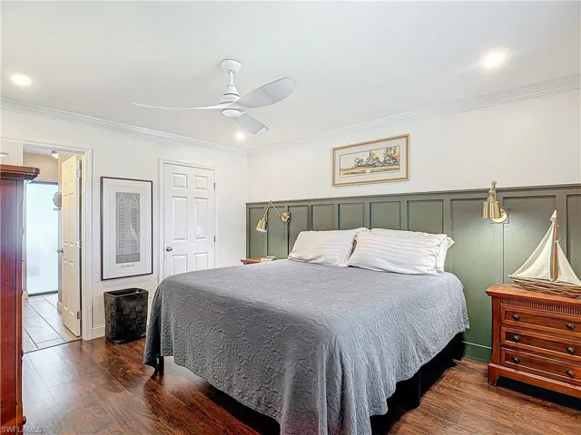Bedroom with ornamental molding, dark wood-style flooring, a ceiling fan, and recessed lighting