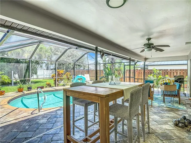 View of pool with a fenced backyard, a patio, a lanai, and a sunroom