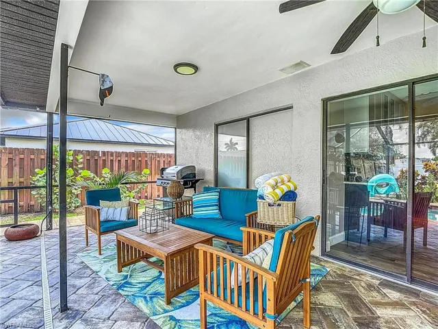 Wooden deck with a patio area, outdoor lounge area, a ceiling fan, and a grill