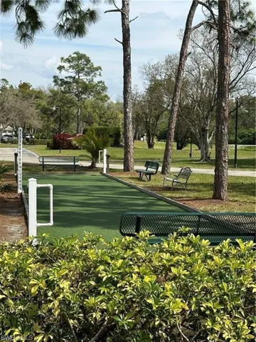 Bocce ball court featuring artificial turf, perimeter curbing, and an integrated score marker