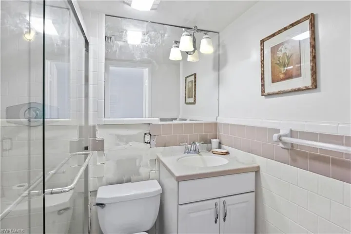 A bright bathroom with a large walk-in shower that combines practicality and elegance for your daily routine.