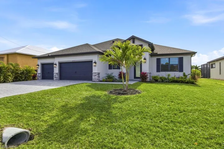 Ranch-style house featuring a front lawn, decorative driveway, stucco siding, a shingled roof, and an attached garage