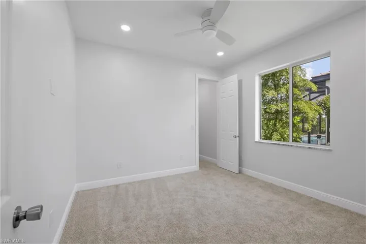 Empty room featuring carpet floors, recessed lighting, and a ceiling fan