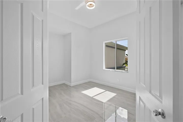 Empty room featuring baseboards and light wood finished floors