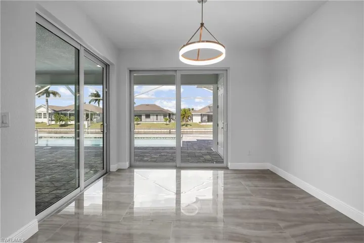 Spare room featuring a residential view and light marble finish floors