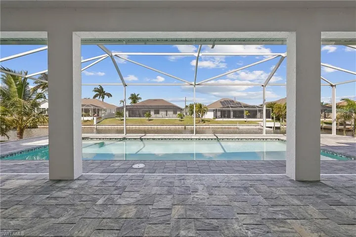Outdoor pool featuring a residential view, a sunroom, a patio area, and a lanai