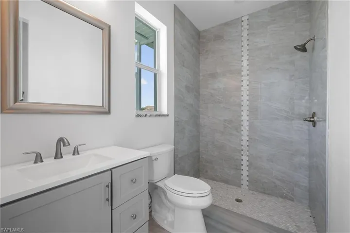 Full bathroom with vanity and a tile shower