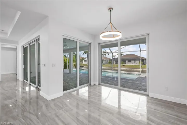 Unfurnished dining area with a sunroom and a residential view