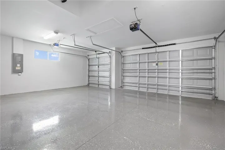 Garage with electric panel and a garage door opener