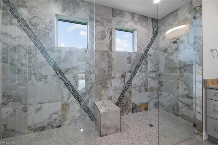 Full bathroom featuring a marble finish shower
