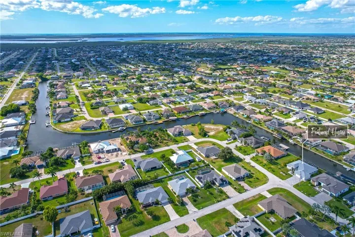 Aerial view of property's location featuring nearby suburban area and a large body of water