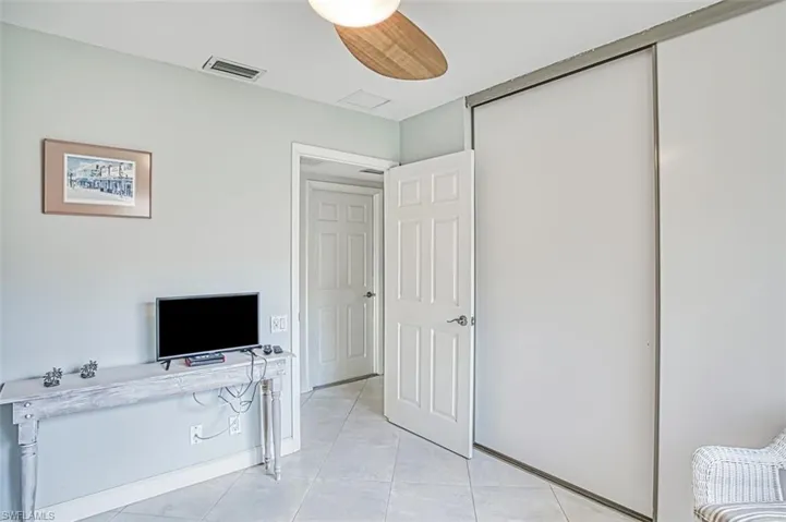 Guest Bedroom featuring light tile patterned floors and a closet