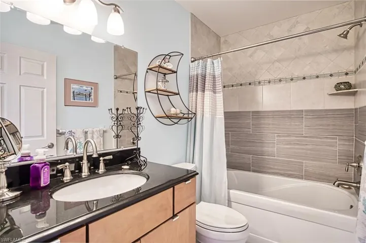 Master Bathroom with vanity, toilet, and shower / bath combo with shower curtain