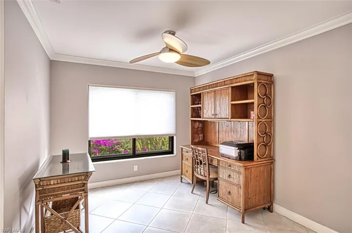 Tiled Den/Office space featuring crown molding and ceiling fan