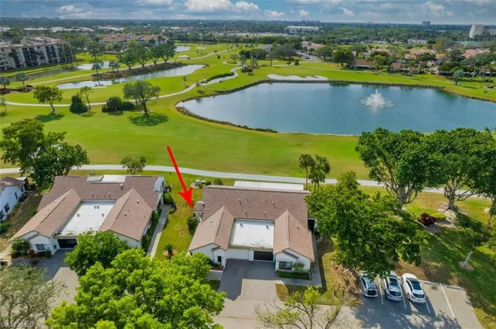 Birds eye view of property with a water view