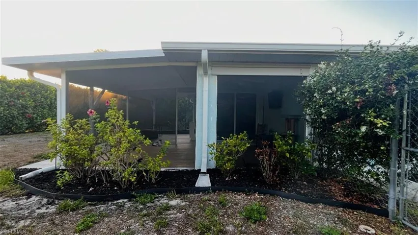 View of side of home featuring a sunroom
