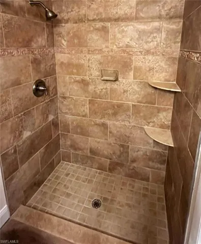 Full bath with a tile shower