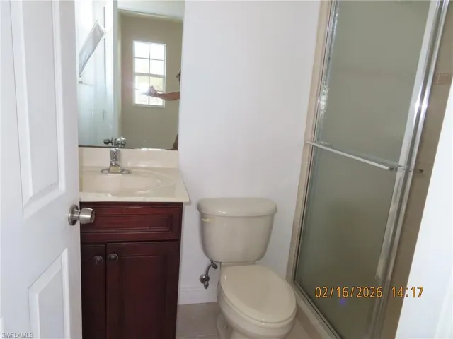 Full bathroom with vanity and a shower stall