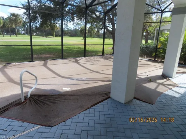 Unfurnished sunroom with golf course view and a patio