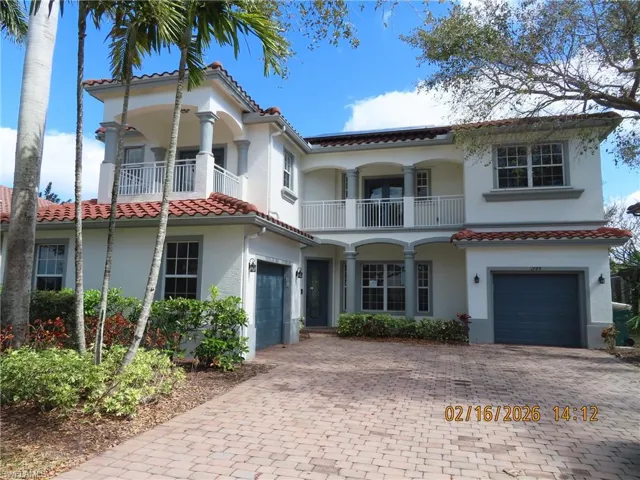 Mediterranean / spanish-style house featuring an attached garage, decorative driveway, a balcony, and stucco siding