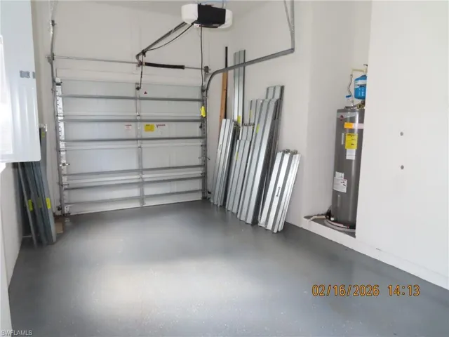 Garage with water heater and a garage door opener