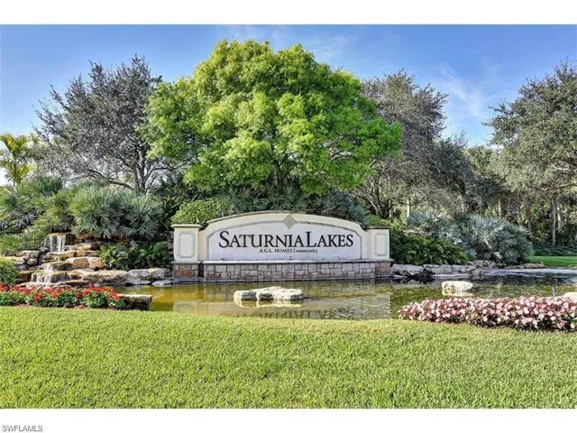 Community / neighborhood sign with a yard